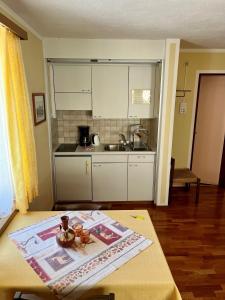 a kitchen with a table with a magazine on it at Hotel Stille in St. Moritz