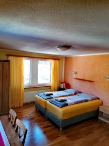 a bedroom with two beds and a window at Hotel Stille in St. Moritz