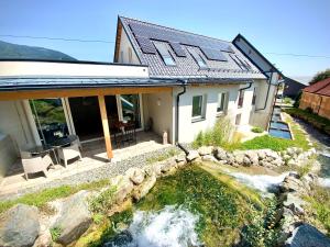 a house with a river in front of it at WATERFRONT - Urbane Eleganz am Bachufer in Villach