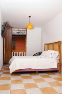 A bed or beds in a room at Hostal Casa Torres Centro Historico - Adults Only