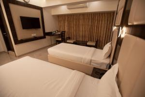 Cama ou camas em um quarto em Hotel Naaz Executive