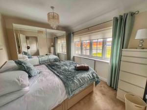 a bedroom with a large bed and a window at Snowdonia Retreat in Bangor