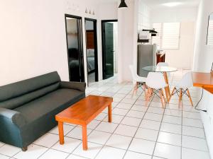 a living room with a couch and a table at Departamentos 1E in Puerto Vallarta