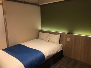 Ліжко або ліжка в номері Hotel Lantana Naha Matsuyama