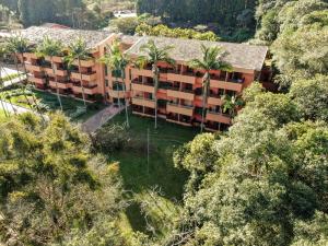 an aerial view of an apartment building with palm trees at Hotel Villa Rossa in São Roque