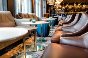 a row of chairs and tables in a restaurant at Motel One Berlin-Bellevue in Berlin