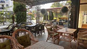 an outdoor seating area with tables and chairs and a patio at Richky Hotel in Truskavets