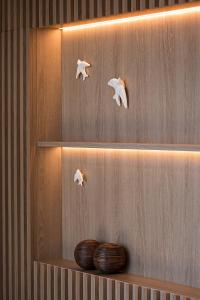 a wooden shelf with three white stuffed animals on it at Hotel Canada in Lisbon