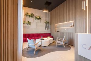 a room with a table and two chairs and a red couch at Hotel Canada in Lisbon