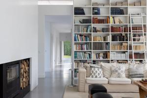 a living room with a couch and a book shelf at Casa Briteiros in Guimarães