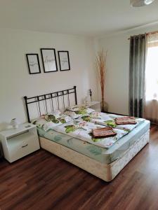 A bed or beds in a room at No°21 Apartman