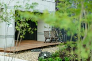 a wooden deck with a chair on a building at Shin-Osaka Station Hotel in Osaka