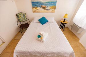 Un dormitorio con una cama con una toalla. en Vieques Tropical Guest House, en Vieques