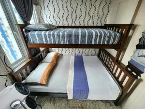 Una cama o camas en una habitación de High-Tech Studio at Grass Residences -2 persons only, Quezon City