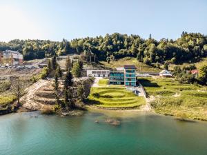 an aerial view of a house on a hill next to a river at Villa Galleria in Colibiţa