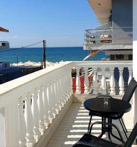 a balcony with a table and chairs and the ocean at Eantos Studios and Suites in Perea