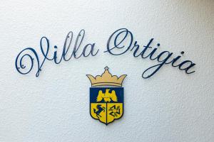 Un certificat, premiu, logo sau alt document afișat la Villa Ortigia