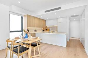 シドニーにあるAdorable 2B Apt near Macquarie Uniのキッチン、ダイニングルーム(テーブル、椅子付)