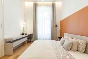 a bedroom with a white bed and a desk at Luxurious Minimalist Residence with Sauna by Prestige Homes in Budapest