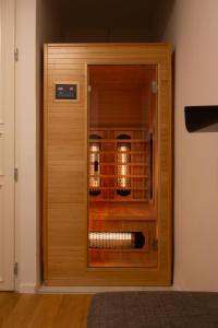 a wooden door to a wine cellar in a room at Luxurious Minimalist Residence with Sauna by Prestige Homes in Budapest