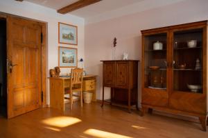 a dining room with a table and a wooden cabinet at Café Burgstraße in Wernigerode