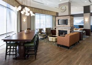 a dining room with a table and a fireplace at Hampton Inn & Suites Boise-Downtown in Boise