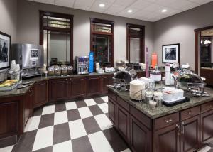 a kitchen with wooden cabinets and a checkered floor at Hampton Inn & Suites Boise-Downtown in Boise