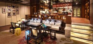 a restaurant with a couch and a table and chairs at DoubleTree by Hilton Guangzhou-Free Shuttle Bus to Canton Fair Complex & Overseas Buyer Registration Services during Canton Fair Period in Guangzhou