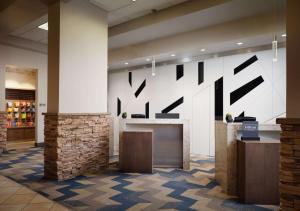 a lobby with a large wall with black letters on it at Hilton Fort Collins in Fort Collins