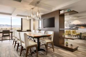 a dining room with a table and chairs at Hilton Fort Collins in Fort Collins