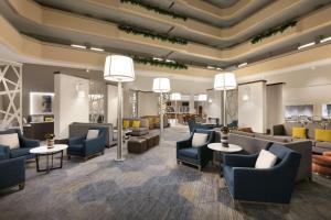 a lobby with couches and chairs and tables at Hilton Fort Collins in Fort Collins