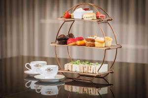 a display of pastries and cups on a table at Hilton Northampton Hotel in Northampton