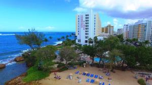 a group of people on a beach near the ocean at The Condado Plaza Hotel in San Juan