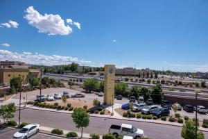 a parking lot with a clock tower in a parking lot at Hampton Inn Albuquerque - University/Midtown in Albuquerque