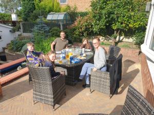 a group of people sitting around a table on a patio at Best Area Close to Leeds Centre in Leeds