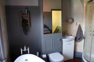 a bathroom with a toilet and a sink and a mirror at Charming 1800s Port Sunlight Worker's Cottage in Port Sunlight