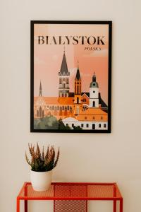 a framed picture of a city skyline on a wall at Flathouse Apartment 2 Centrum in Białystok