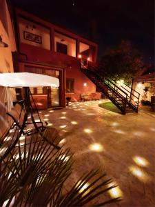 a building with stairs and a patio at night at Artista B&B in Càbras