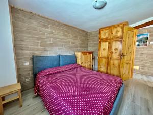 Una cama o camas en una habitación de Nido Del Cervino - Ingresso Indipendente