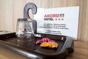 a plate of food sitting on a table with a lantern at Mini Hotel Akord in Ostrava