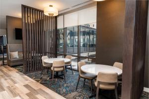 two tables and chairs in a room with windows at Residence Inn by Marriott Grand Rapids Downtown in Grand Rapids