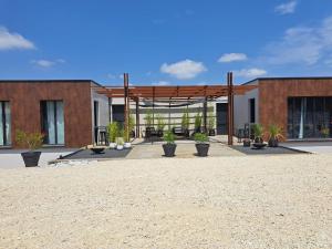 a pavilion with potted plants in front of a building at Le 7 in Vieille-Toulouse