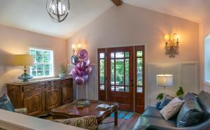 a living room with a couch and a table and balloons at Inn at Rose Hall in Eureka Springs