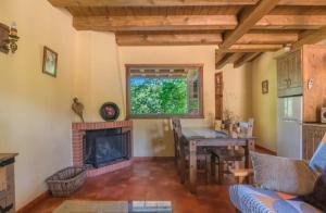 a living room with a fireplace and a table at Complejo Rural Las Palomas in Jerte