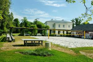 a park with a picnic table and a playground at Burbiskio dvaras in Anykščiai