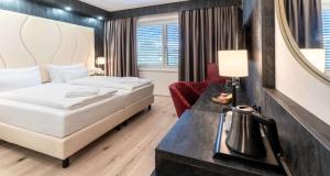 A bed or beds in a room at PLAZA INN Wiener Neustadt, BW Signature Collection