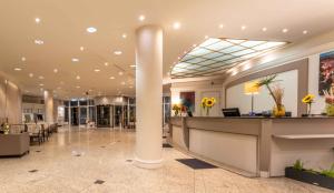 a lobby with a column in the middle of a building at PLAZA Premium Wien in Vienna