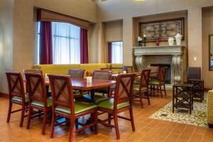 a dining room with a table and chairs and a fireplace at Hampton Inn & Suites Mountain Home in Mountain Home