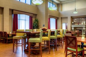 a restaurant with tables and chairs and a fireplace at Hampton Inn & Suites Mountain Home in Mountain Home