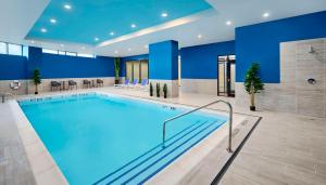 a large pool in a hotel with blue walls at Hampton Inn By Hilton Hamilton in Hamilton